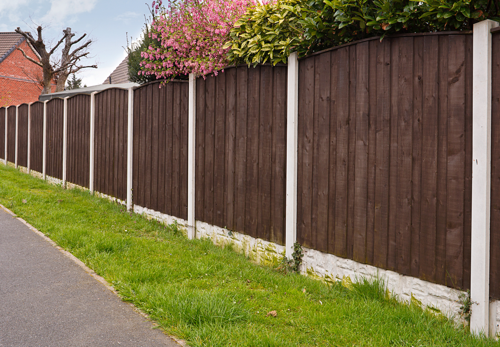 A length of fence made of wood-looking material