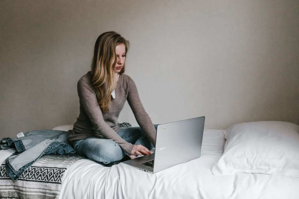 Woman writing at a laptop